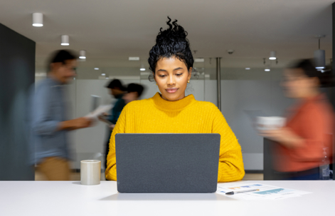 a woman working in a busy office